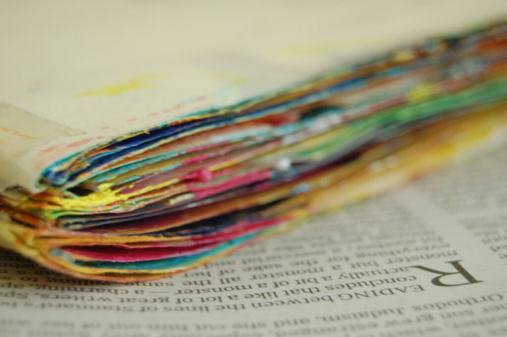 The colorful edges of art journal pages.