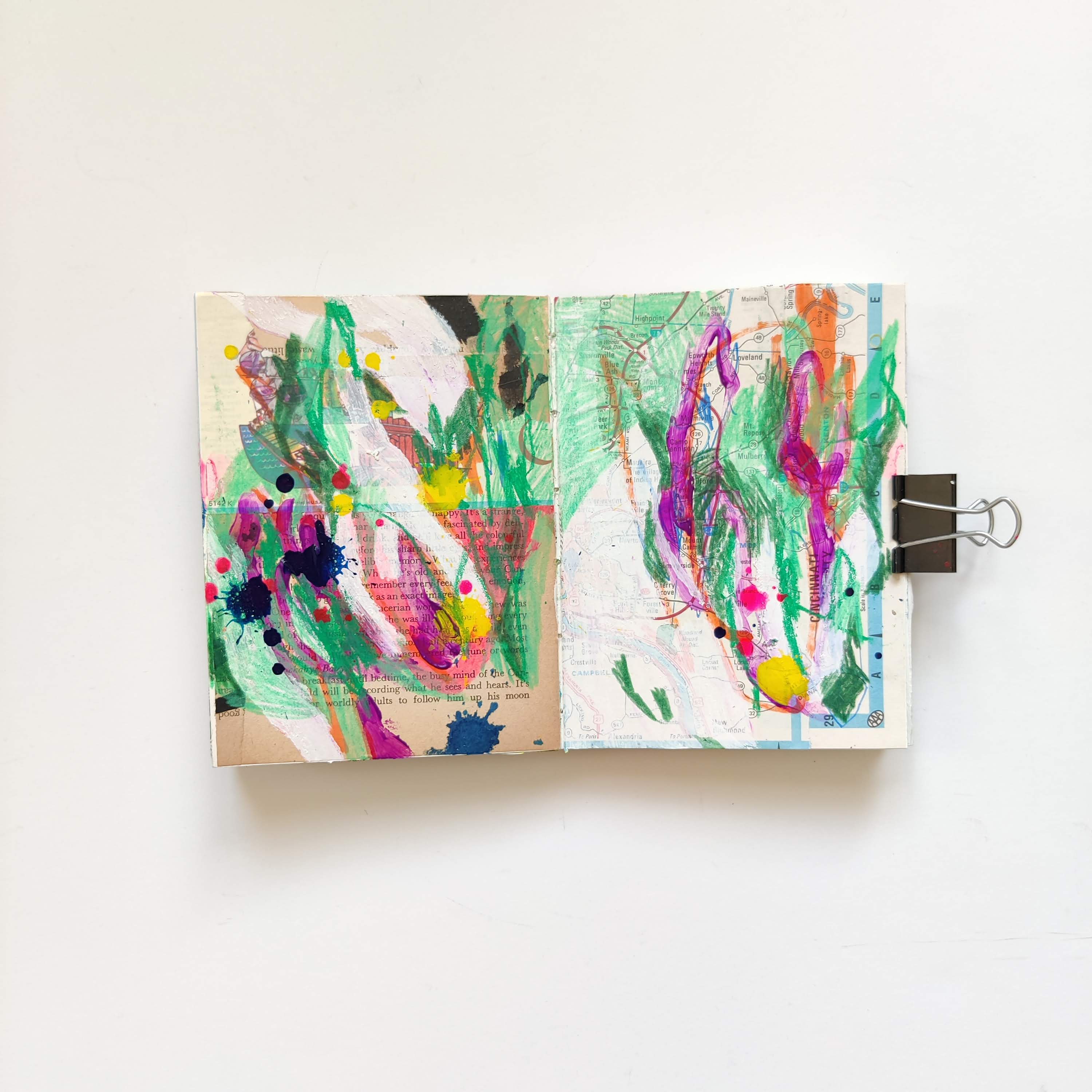 Ingrid Murray mixed media art journal. A neutral background of vintage book and atlas papers, and abstract white green, purple, orange, dark blue, and yellow marks made with tempera paint, oil pastel, colored pencil, and acrylic ink.