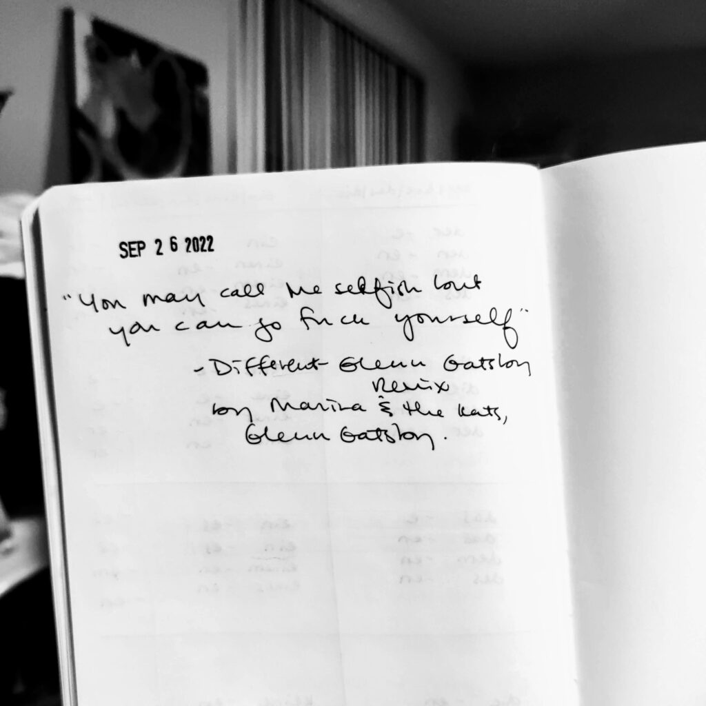 Black and white photo of a journal page. At the top is the date — Sep 26, 2022 — and underneath is written: "'You may call me selfish but you can go fuck yourself.' - Different - Glenn Gatsby Remix by Marina & the Kats, Glenn Gatsby"