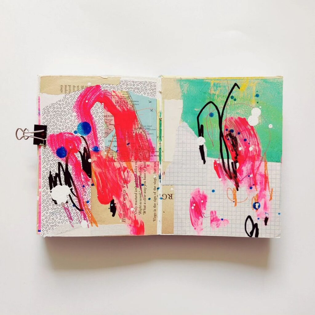 An open mixed media art journal. A layer of mostly neutral collage (and one large teal painted paper) is topped with energetic marks and drips in black, neon pink, white, orange, and blue. Most of the background shows through.