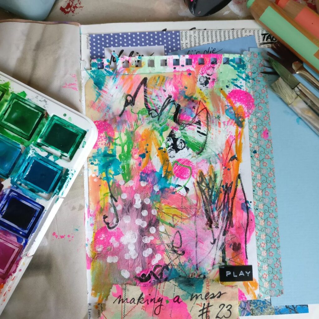 Mixed media art journal page with energetic paint marks in neon pink, teal, orange, and black.